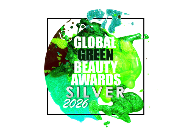 A graphic badge or sticker design for the 'Global Green Beauty Awards Silver 2026' featuring bold white and green text over a vibrant green, teal, and black paint-splattered circular background, framed by a thin black square line on a white canvas.