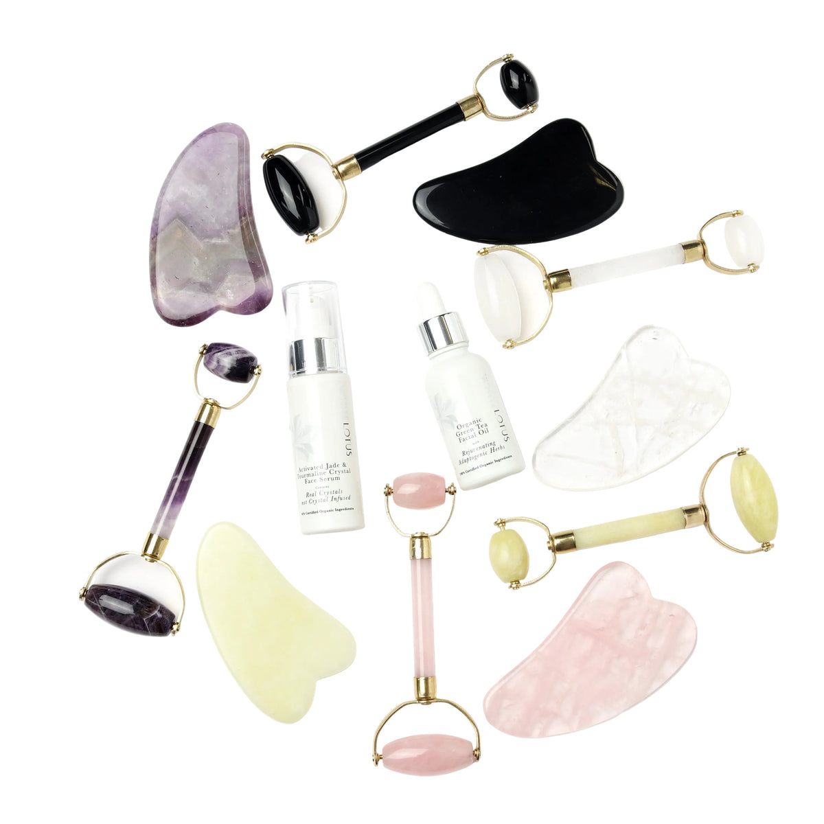An assortment of beauty instruments and skincare products from White Lotus, including gua sha boards and rollers, displayed on a white background.