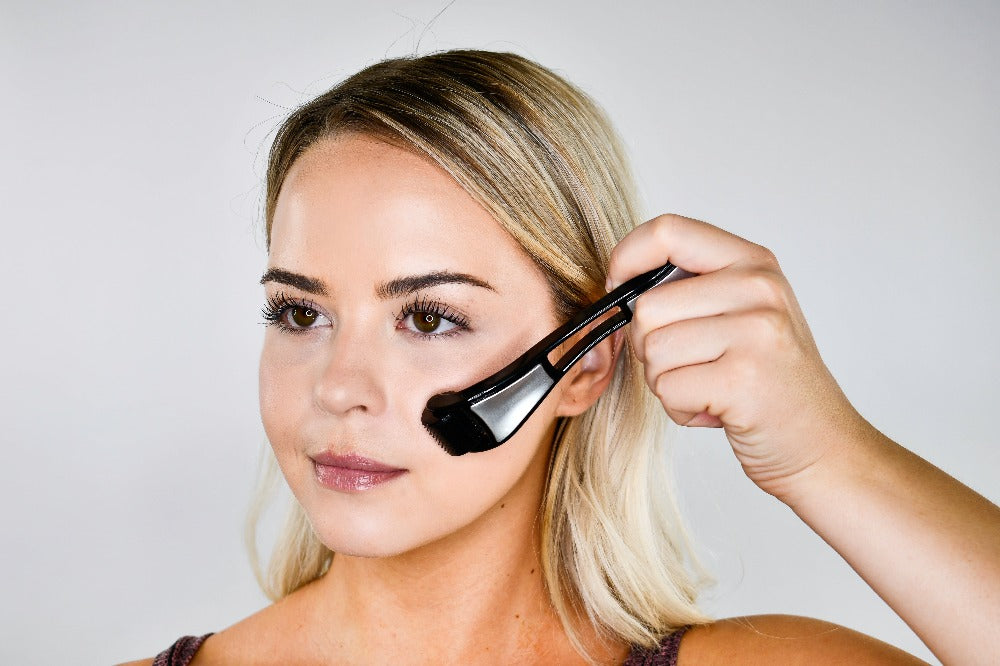 A lady using a microneedle roller for scarring on the face