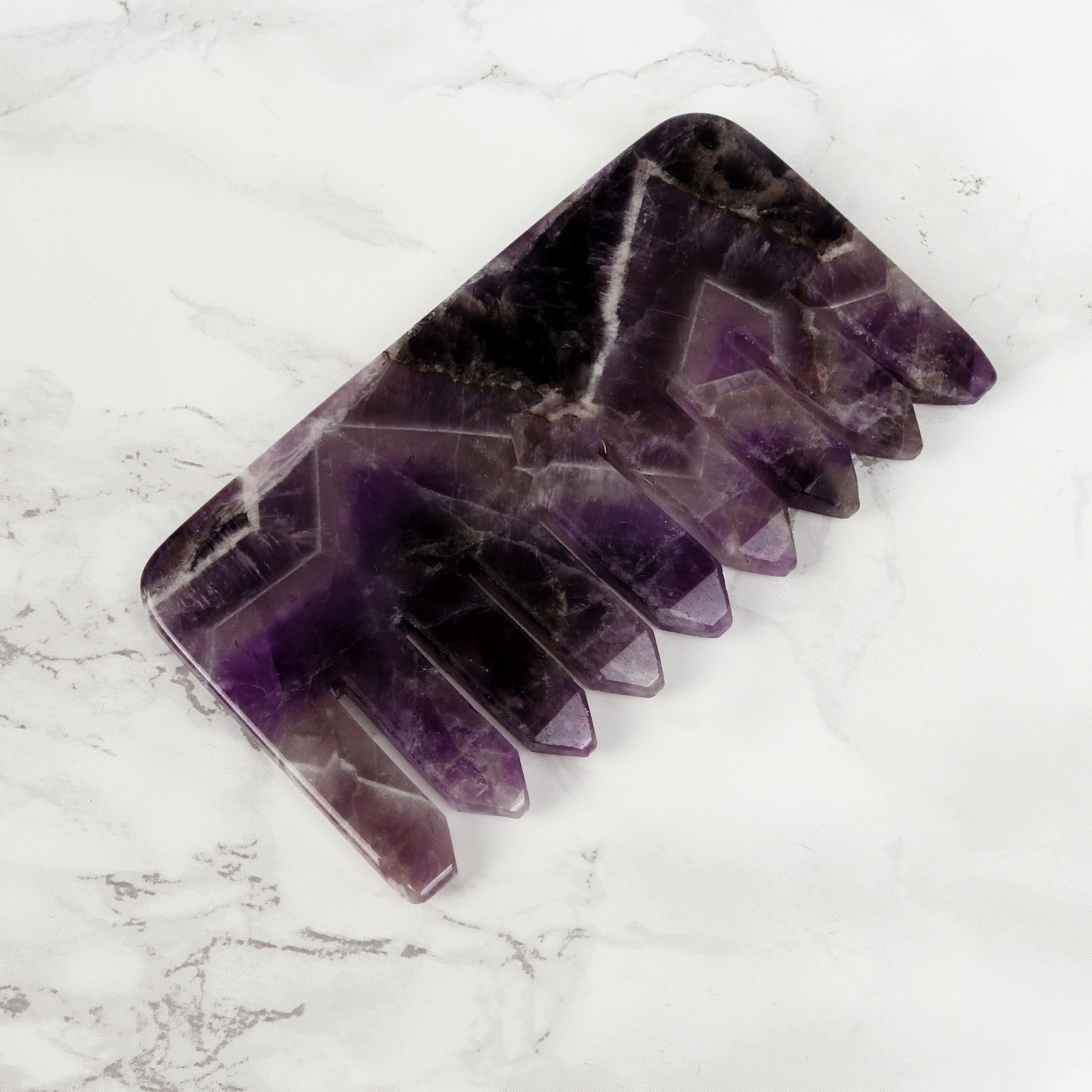 Amethyst Crystal Hair Comb on marble background
